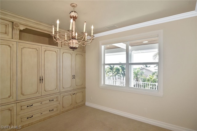 interior space featuring a notable chandelier, crown molding, and light colored carpet