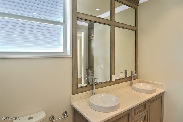 bathroom with vanity and toilet