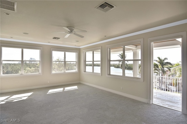 carpeted empty room featuring crown molding and ceiling fan