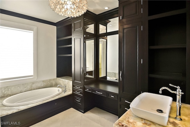 bathroom featuring a bathing tub, sink, tile patterned floors, and a chandelier