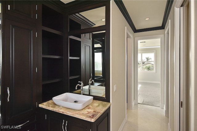 bathroom featuring tile patterned flooring, ornamental molding, and vanity