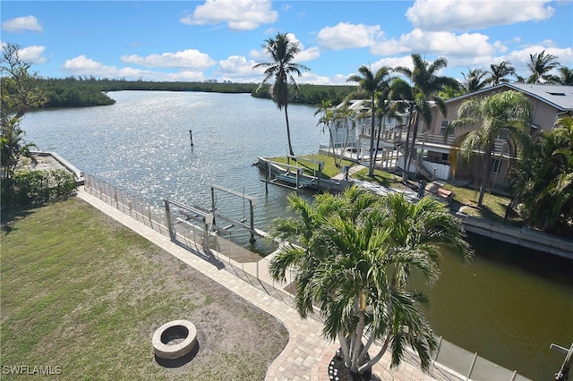 view of water feature with a dock and a fire pit