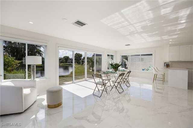 sunroom / solarium with a water view