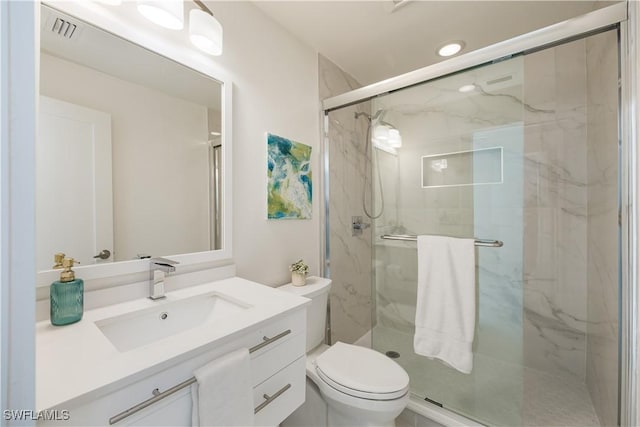 bathroom featuring walk in shower, vanity, and toilet