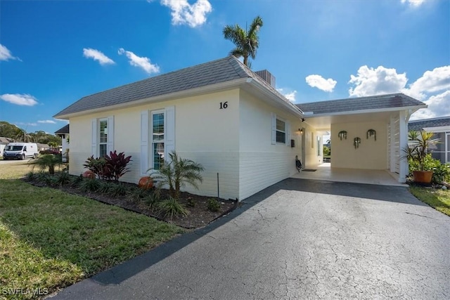 view of side of home featuring a carport