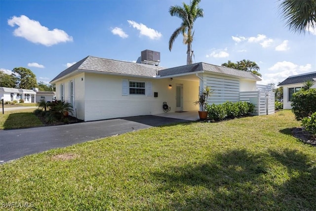 view of front of property with central AC unit and a front yard