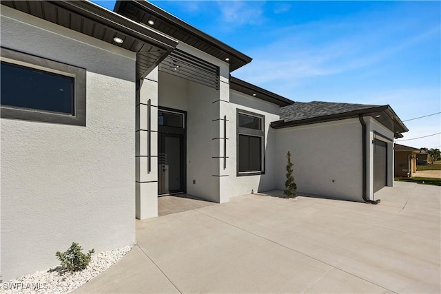 view of side of home with a garage and a patio area