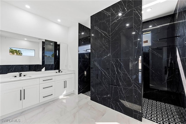 bathroom with vanity and a tile shower