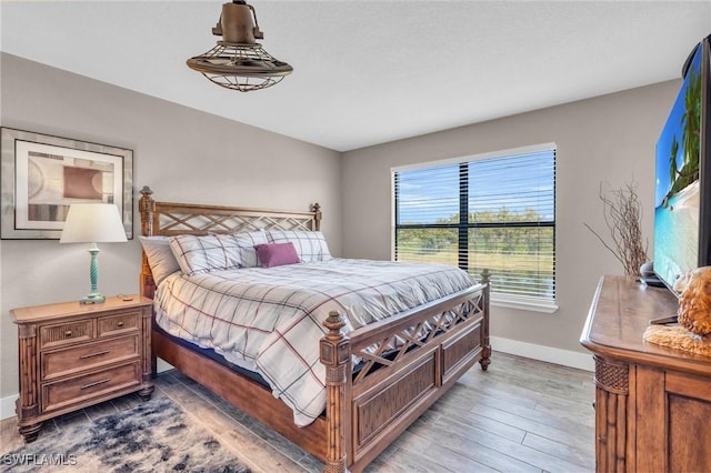 bedroom with wood-type flooring