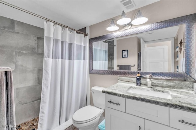 bathroom with vanity, toilet, and a shower with shower curtain