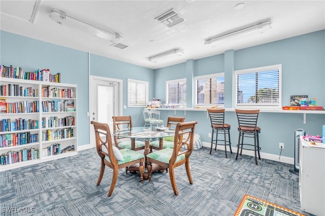 dining room featuring a wealth of natural light and carpet