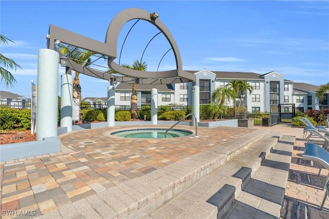 view of swimming pool with a community hot tub