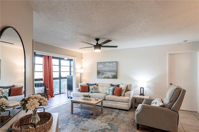 tiled living room with ceiling fan and a textured ceiling