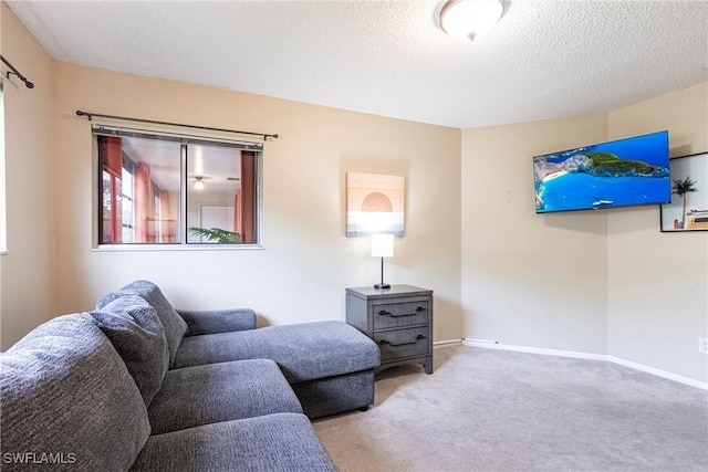 carpeted living room featuring a textured ceiling