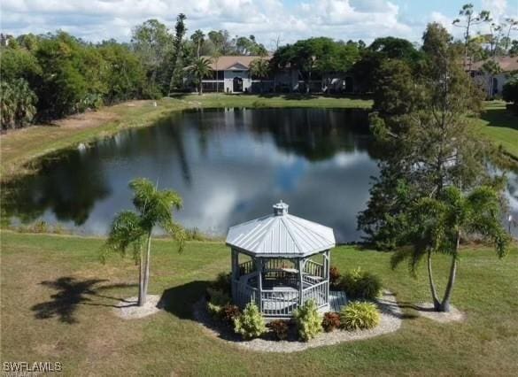 view of community featuring a gazebo, a water view, and a lawn