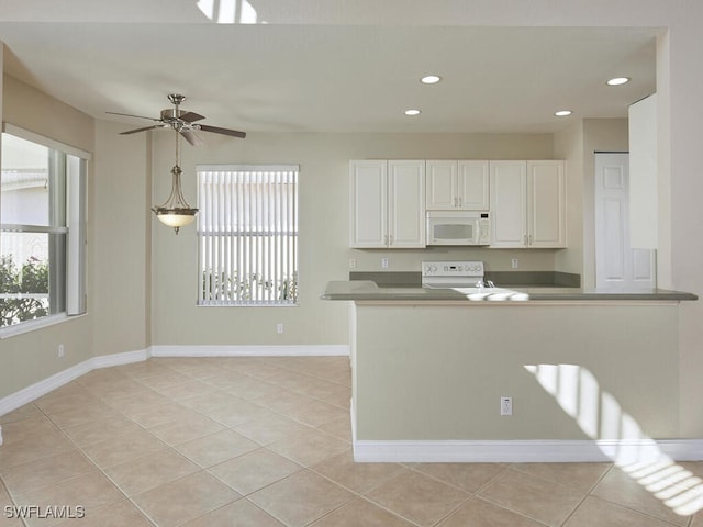 kitchen with white cabinetry, hanging light fixtures, light tile patterned floors, electric range, and ceiling fan