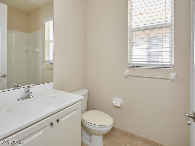 bathroom featuring vanity, tile patterned floors, a shower, and toilet