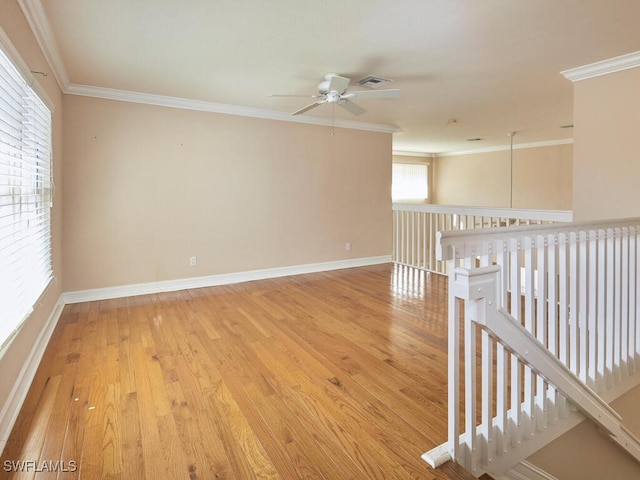 empty room featuring ornamental molding, hardwood / wood-style floors, and ceiling fan