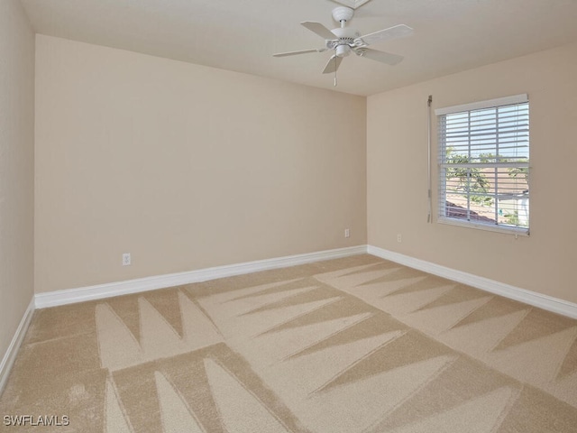 carpeted empty room featuring ceiling fan