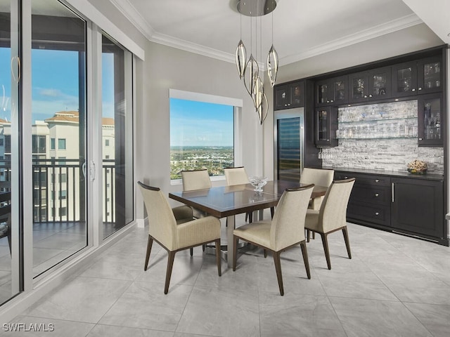 tiled dining room featuring crown molding