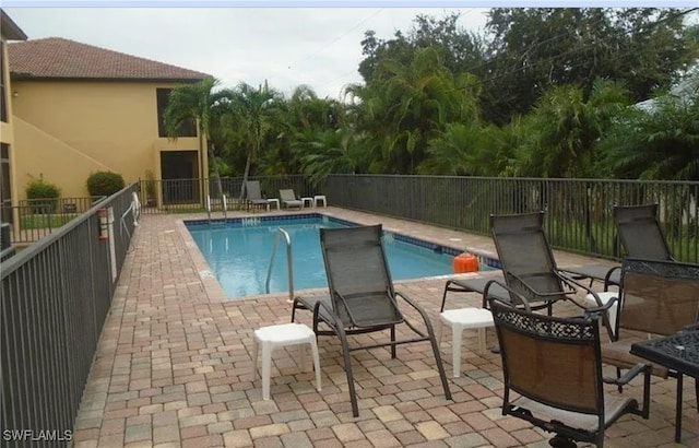 view of swimming pool with a patio area