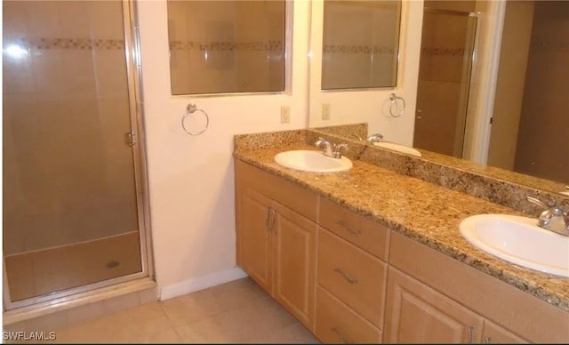 bathroom featuring an enclosed shower, vanity, and tile patterned flooring