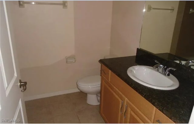 bathroom with vanity, toilet, and tile patterned flooring