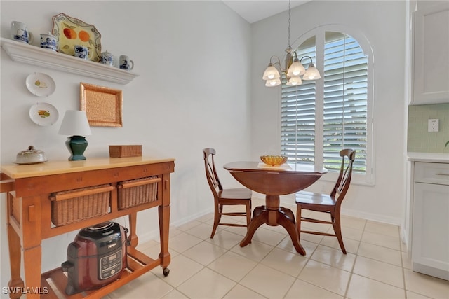 tiled dining area with an inviting chandelier