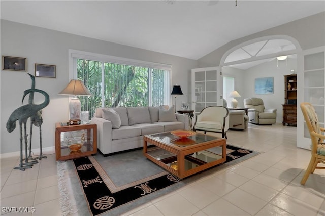 living room with lofted ceiling and light tile patterned floors