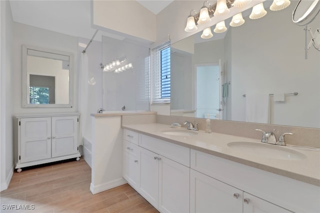 bathroom featuring vanity, hardwood / wood-style flooring, and walk in shower