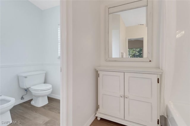 bathroom with a bidet and toilet