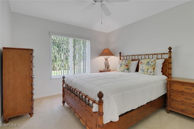 bedroom featuring light colored carpet and ceiling fan