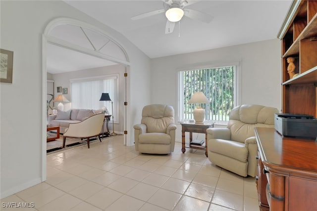 sitting room featuring light tile patterned floors, vaulted ceiling, and ceiling fan