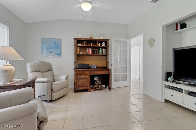 living room with lofted ceiling, light tile patterned floors, and ceiling fan