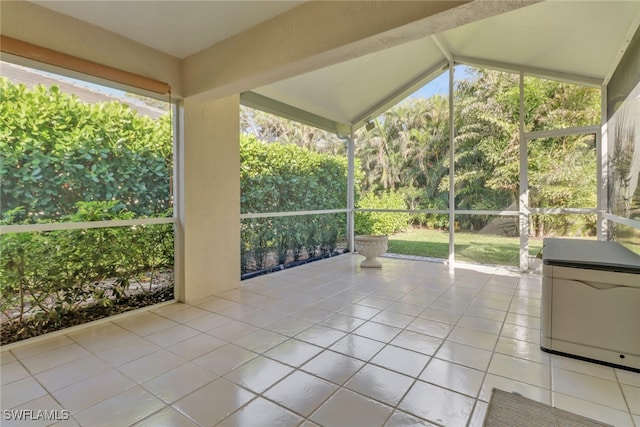 unfurnished sunroom featuring plenty of natural light and lofted ceiling