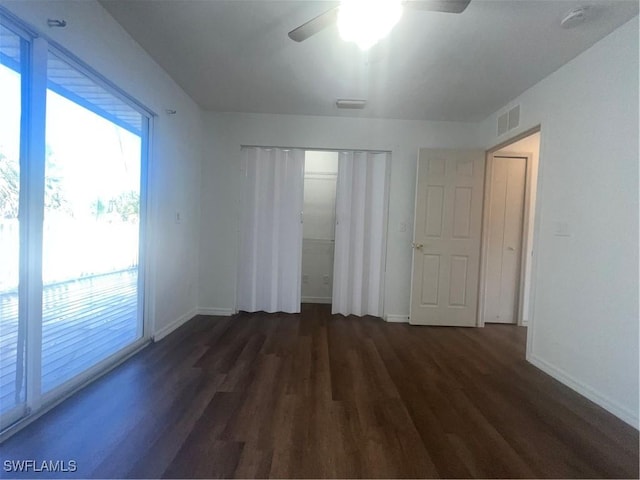 spare room with dark hardwood / wood-style floors and ceiling fan