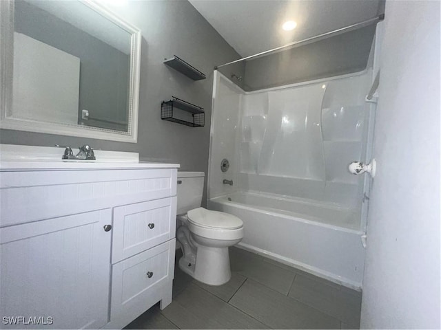 full bathroom with tile patterned flooring, bathing tub / shower combination, vanity, and toilet