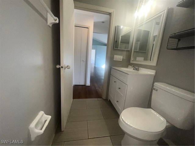 bathroom featuring tile patterned floors, toilet, and vanity