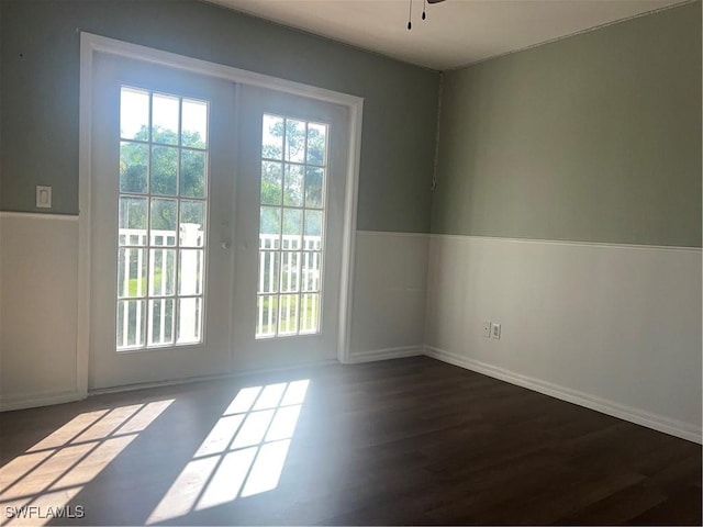 doorway with plenty of natural light, dark wood-type flooring, ceiling fan, and french doors