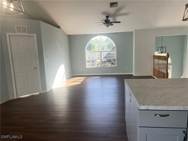 interior space featuring vaulted ceiling, dark hardwood / wood-style floors, and ceiling fan