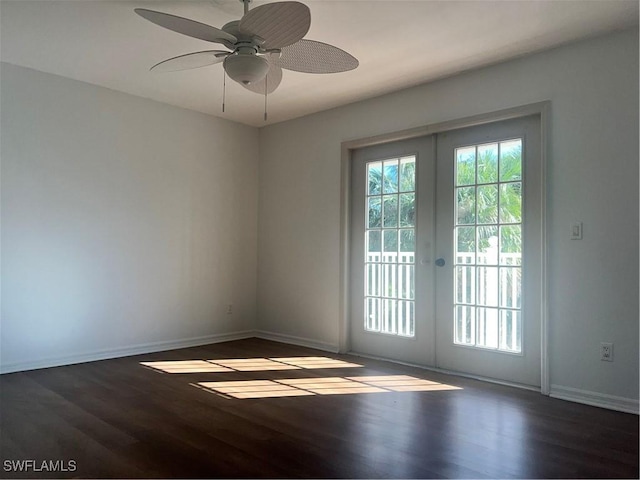 doorway featuring dark wood-type flooring, ceiling fan, and french doors