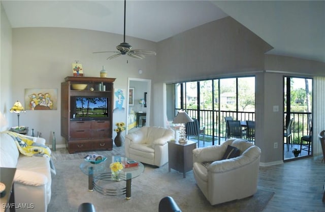 living room featuring lofted ceiling, wood-type flooring, and ceiling fan