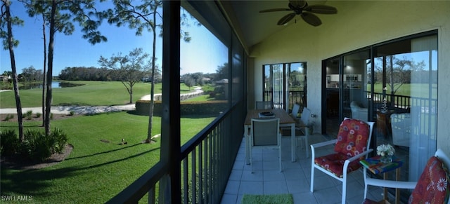 sunroom featuring ceiling fan and vaulted ceiling