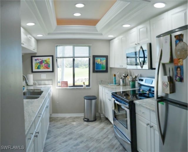 kitchen featuring white cabinetry, sink, a raised ceiling, and appliances with stainless steel finishes