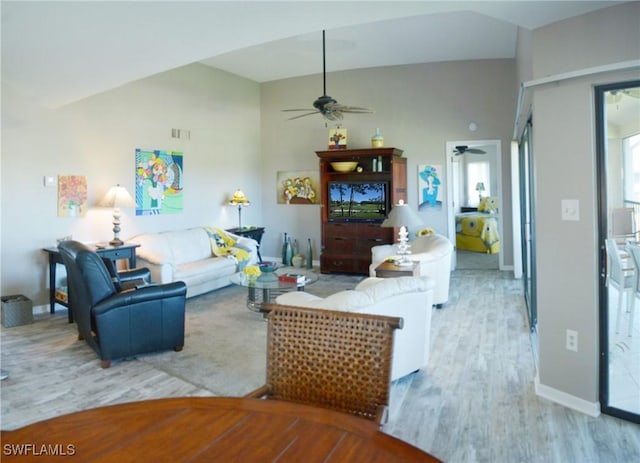 living room featuring high vaulted ceiling, ceiling fan, and light hardwood / wood-style flooring