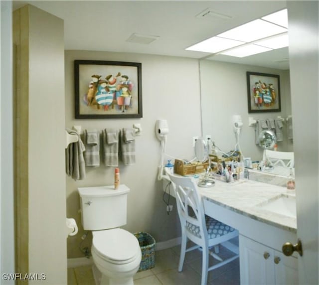 bathroom featuring vanity, tile patterned floors, and toilet