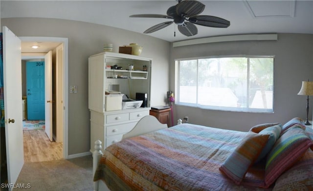 bedroom featuring light colored carpet and ceiling fan