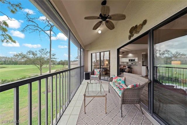 sunroom featuring lofted ceiling and ceiling fan