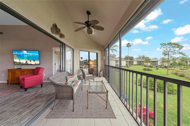 sunroom featuring ceiling fan and lofted ceiling