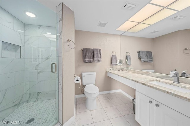 bathroom featuring vanity, tile patterned floors, toilet, and walk in shower